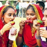 Girls enjoy ice candy during Baisakhi mela organised by Doordarshan Kendra in Jalandhar