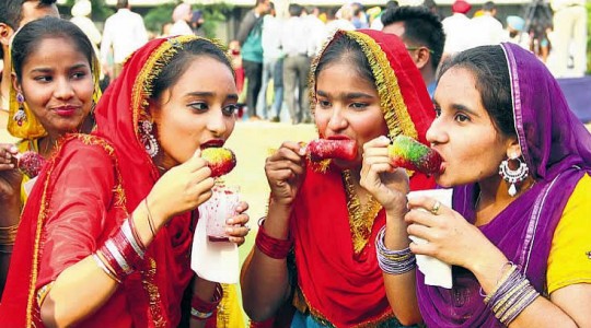 Girls enjoy ice candy during Baisakhi mela organised by Doordarshan Kendra in Jalandhar