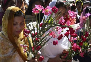 Pakistani Christian women pray during a Palm Sunday mass in St. Anthony church in Lahore, Pakistan