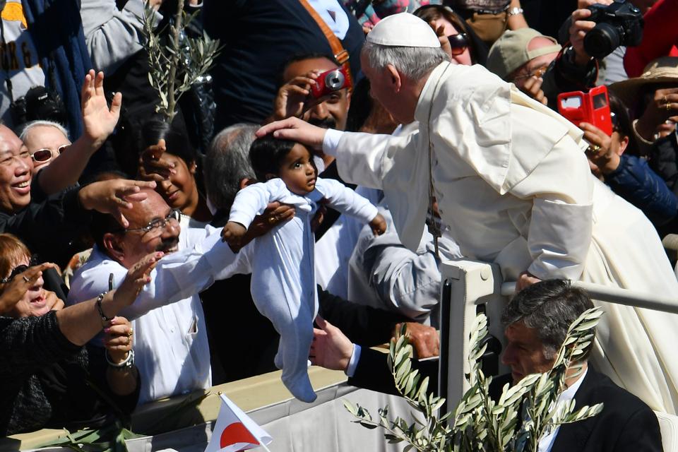 Pope Francis blesses a child at the end of the Palm Sunday mass, on April 9, 2017 at St Peter's square in Vatican