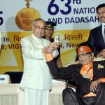 President Pranab Mukherjee being received a Shain Baba statue from Dadasaheb Phalke Award winner Manoj Kumar at the 63rd National Film Awards 2015 function at Vigyan Bhawan in New Delhi on Tuesday. I & B Minister Arun Jaitley and Minister of State Rajyavardhan Singh Rathore are also seen.