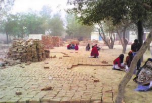Students at a demolished school in Surghuri village of Faridkot