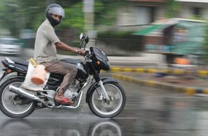 A motorcyclist rides during pre-monsoon rain in Karnal on June 15, 2015. Pre-monsoon showers lashed several parts of the region.