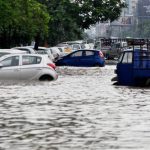 A view of vehicles submerged in floodwater a spell of heavy rainfall in Guwahati on Juen 16, 2016.