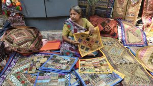 Prem Rani, 60, has been hawking embroidered cushion covers at the bustling Janpath market for the past thirty years. A mother of two, both of whom are now married and have children of their own.