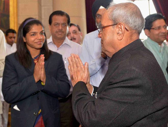 President Pranab Mukherjee is greeted by bronze medal winner wrestler Sakshi Malik at the National Sports and Adventure Award 2016 function at Rashtrapati Bhawan in New Delhi on August 29, 2016.