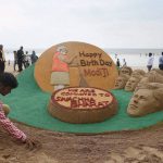 Sand artist Sudarsan Patnaik showcases his sand sculpture wishing Prime Minister Narendra Modi on his 67th birthday, in Mumbai on September 17, 2016.