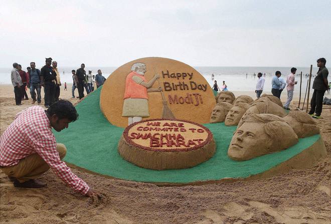 Sand artist Sudarsan Patnaik showcases his sand sculpture wishing Prime Minister Narendra Modi on his 67th birthday, in Mumbai on September 17, 2016.