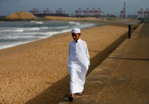 A Muslim boy walks along the beach ahead of Eid al-Adha in Colombo, Sri Lanka.
