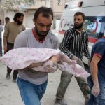 A Syrian man carries the body of an infant retrieved from under the rubble of a building following a reported airstrike on September 23, 2016, on the al-Muasalat area in the northern Syrian city of Aleppo.