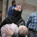 A Syrian woman carries the body of her infant after he was retrieved from under the rubble of a building following a reported airstrike on September 23, 2016, on the al-Muasalat area in the northern Syrian city of Aleppo.