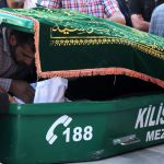 A father looks at his son`s body lying in a coffin on April 19, 2016 in Kilis during a funeral of two children who were killed by rockets hitting a house the day before.
