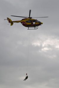 A rescuer is lifted back into a helicopter of the Securite Civile, France's civil defence agency, after assisting stranded residents following floods on June 1, in Nemours, southeast of Paris.