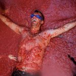 A reveller is covered with tomato pulp during the annual 'Tomatina' (tomato fight) festival in Bunol near Valencia, Spain on August 31, 2016