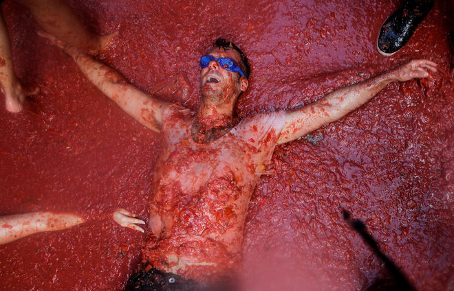 A reveller is covered with tomato pulp during the annual 'Tomatina' (tomato fight) festival in Bunol near Valencia, Spain on August 31, 2016