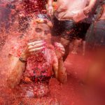 A reveller lies in tomato pulp during the annual Tomatina festival in Bunol near Valencia, Spain on August 31, 2016.