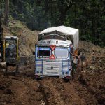 An Indian truck driver makes his way through heavily rutted mud on National Highway 44 (NH-44) at Khasiapunji some 205 kms north of Agartala on the border of the north-eastern states of Assam and Tripura on July 5, 2016.