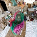 An internally-displaced Afghan child rests in a hanging cot inside a shelter at a refugee camp in Kabul, Afghanistan, on May 31, 2016.