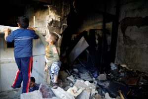 Children play inside a devastated house struck by rocket fire from Syria in Turkey's southeastern border town of Kilis on May 10.