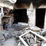 Children play inside a devastated house that was struck by rocket fire from Syria in Turkey's southeastern border town of Kilis on May 10.