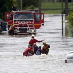 French firefighters on a small boat evacuate residents from a flooded area after heavy rain falls in Chalette-sur-Loing, near Orleans, France, June 1.