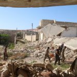 Harakat Nour al-Din al-Zenki fighters walk near damaged buildings in Handarat area, north of Aleppo, Syria, April 19, 2016.
