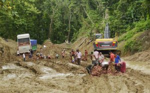 Indian labourers work to clear a landslide on the National Highway 44 at Khasiapunji some 75 kms north of Karimganj on the border of the north-eastern states of Assam and Tripura on July 11, 2016