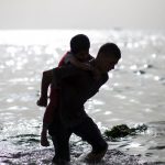 Palestinian children play in the water on the beach on May 14 at the al-Shati refugee camp in Gaza City.