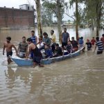 People being rescued by Municipal Corporation employees from flood affected Sharda Nagar colony in Bhopal on July 9, 2016.