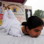 People doing yoga at M A Stadium, in Jammu