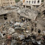 People gather at the site of a Saudi-led air strike in Yemen's capital Sanaa on September 21, 2015.