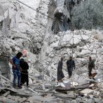 People inspect a damaged site after airstrikes on the rebel held Tariq al-Bab neighbourhood of Aleppo, Syria, on September 23, 2016.