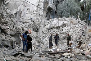 People inspect a damaged site after airstrikes on the rebel held Tariq al-Bab neighbourhood of Aleppo, Syria, on September 23, 2016.
