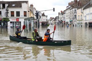 People paddle in a craft in a flooded street on June 1, in Nemours. Torrential downpours have lashed parts of northern Europe in recent days, leaving four dead in Germany, breaching the banks of the Seine in Paris and flooding rural roads and villages.