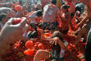 People participate in the tenth annual tomato fight festival, known as ‘tomatina’, in Sutamarchan, Boyaca department, Colombia, on June 5, 2016.