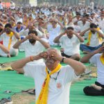 People perform yoga on the occasion of 2nd International Yoga Day at Karna stadium in Karnal