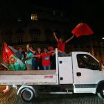 Portugal supporters celebrate near the Arc de Triomphe after the Euro 2016 football tournament final match between Portugal and France on July 10, 2016 in Paris.