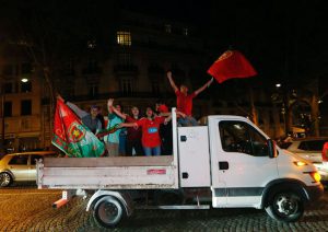 Portugal supporters celebrate near the Arc de Triomphe after the Euro 2016 football tournament final match between Portugal and France on July 10, 2016 in Paris.