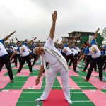 Prime Minister Narendra Modi participates in a mass yoga session along with other Indian yoga practitioners to mark the 2nd International Yoga Day at Capitol complex in Chandigarh on June 21.