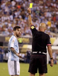 Referee gives Argentina's Lionel Messi a yellow card during the final of the Copa America Centenario against Chile, on Sunday, in East Rutherford, N.J.