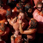 Revellers pelt oneanother with tomato pulp during the annual