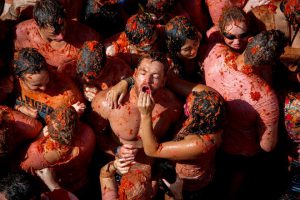 Revellers pelt oneanother with tomato pulp during the annual