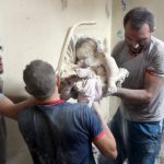 Syrian civil defence volunteers, known as the White Helmets, retrieve bodies from under the rubble of a building following a reported airstrike on September 23, 2016, on the al-Muasalat area in the northern Syrian city of Aleppo.