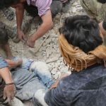 Syrians dig the body of a child out from under the rubble of a building following bombardment on the al-Marja neighbourhood of the northern Syrian city of Aleppo on September 23, 2016.