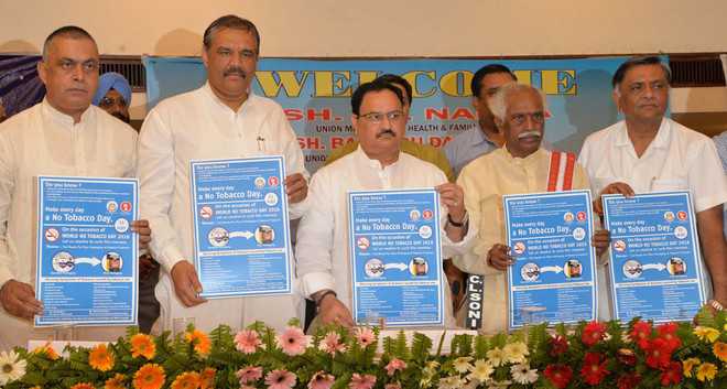 Union Minister JP Nadda and other dignitaries release a poster and below students of St Soldier School take out an awareness rally to mark the World No Tobacco Day in Jalandhar