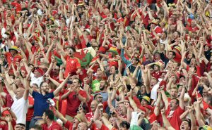 Wales fans celebrate their team's 2-1 win over Slovakia in the Euro 2016 group B football match between Wales and Slovakia at the Stade de Bordeaux in Bordeaux on June 11, 2016.
