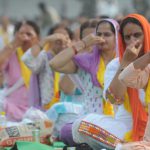 Women perform yoga on the occasion of 2nd International Yoga Day at Karna stadium in Karnal
