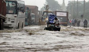 An Indian man pulls his cart through floodwaters in Hero Honda chowk during a monsoon downpour in Gurgaon.