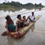 Indian villagers take rest on a raft in the flood-affected Bordiya Kacharigoan village in Morigoan district, some 70 kms from Guwahati in Assam.