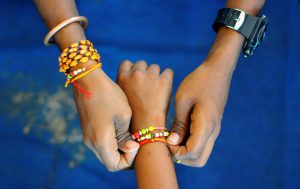 A boy ties Rakhi on the wrist of a girl during Raksha Bandhan celebrations in Bengaluru.